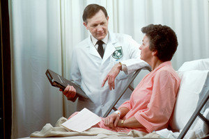 doctor consulting with patient and spouse